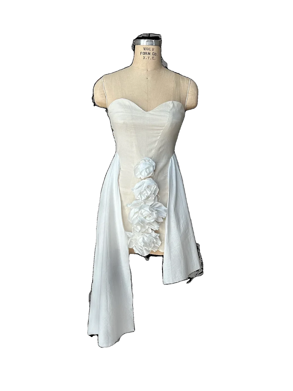 White Passion toile with asymmetric floral construction on a dress form.